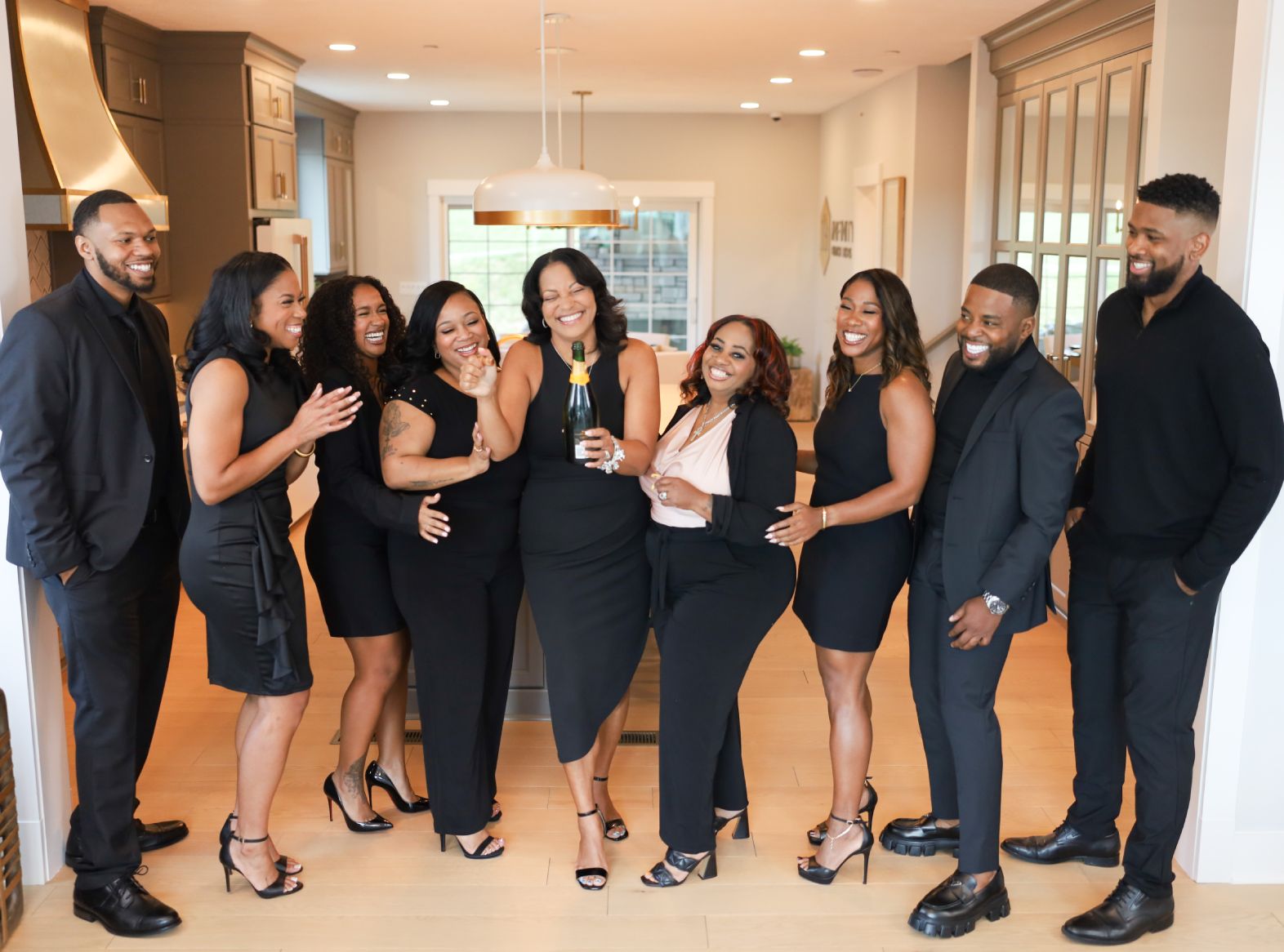 The Hill Real Estate Group team together in a bright kitchen